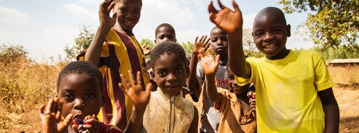 Image of smiling, waving children